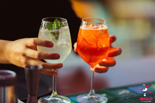 Summer aperitivo along Florence's riverbanks with panoramic view of the Arno at sunset