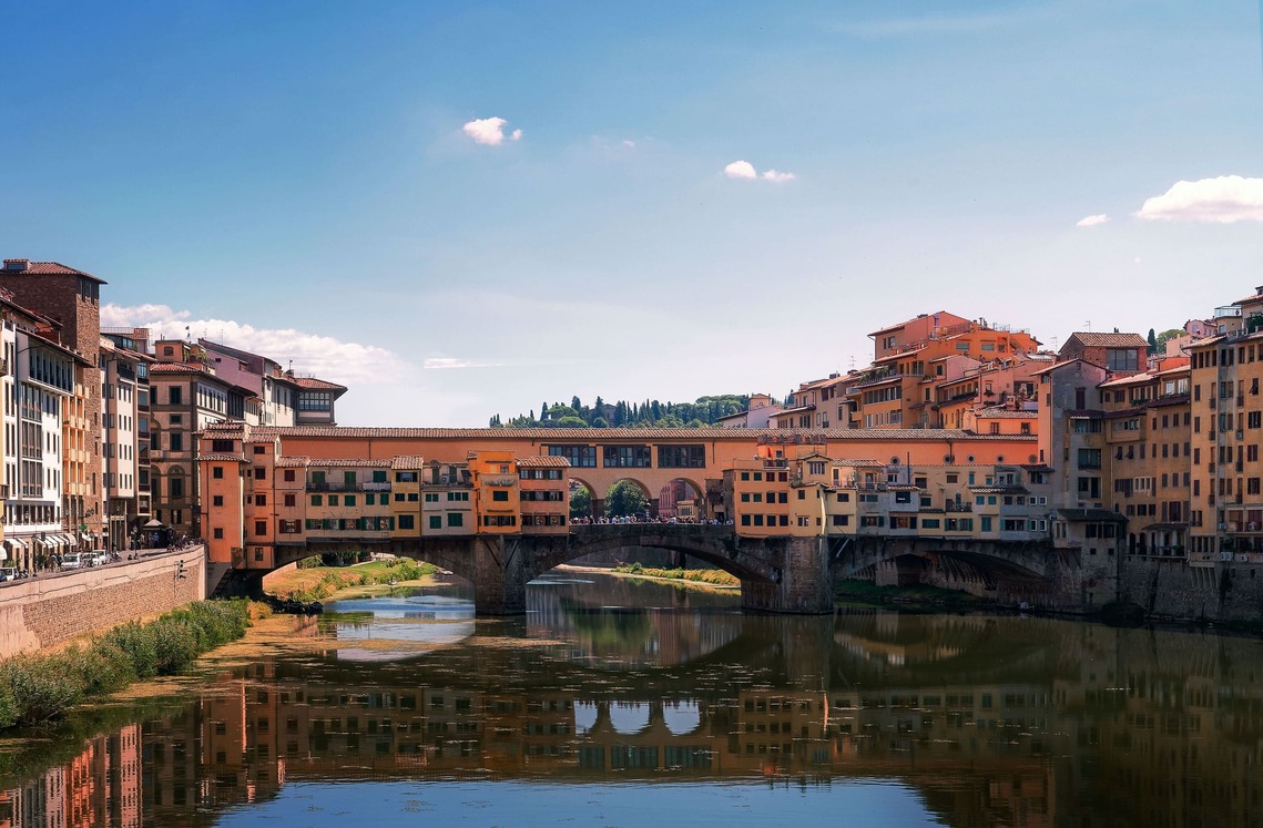 A panoramic view of the Ponte Vecchio over the Arno River in Florence, Italy